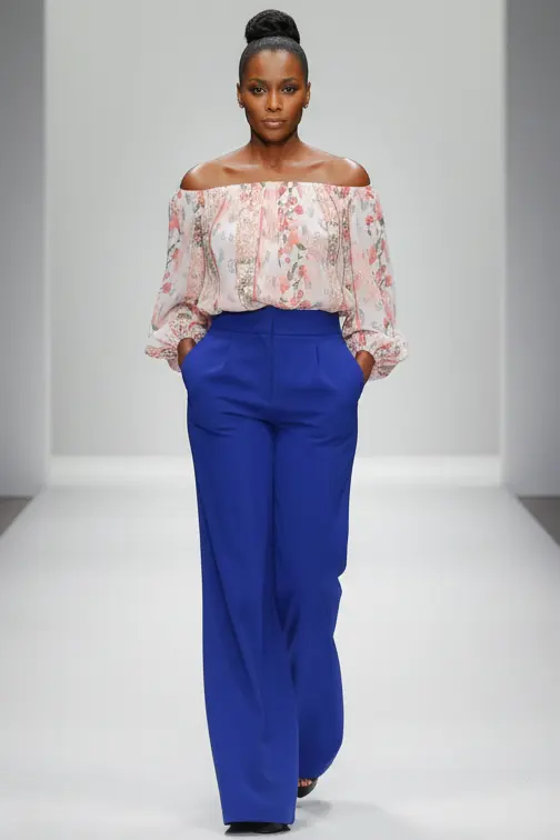 Elegance floral off-shoulder blouse with cobalt trousers on runway